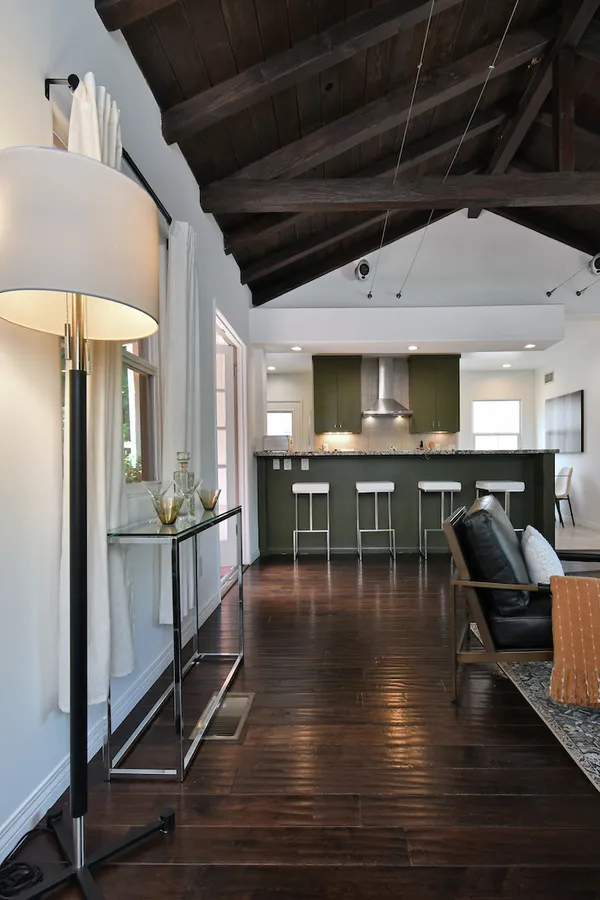 a dining hall with stainless steel appliances granite countertop a sink a stove a dining table and chairs