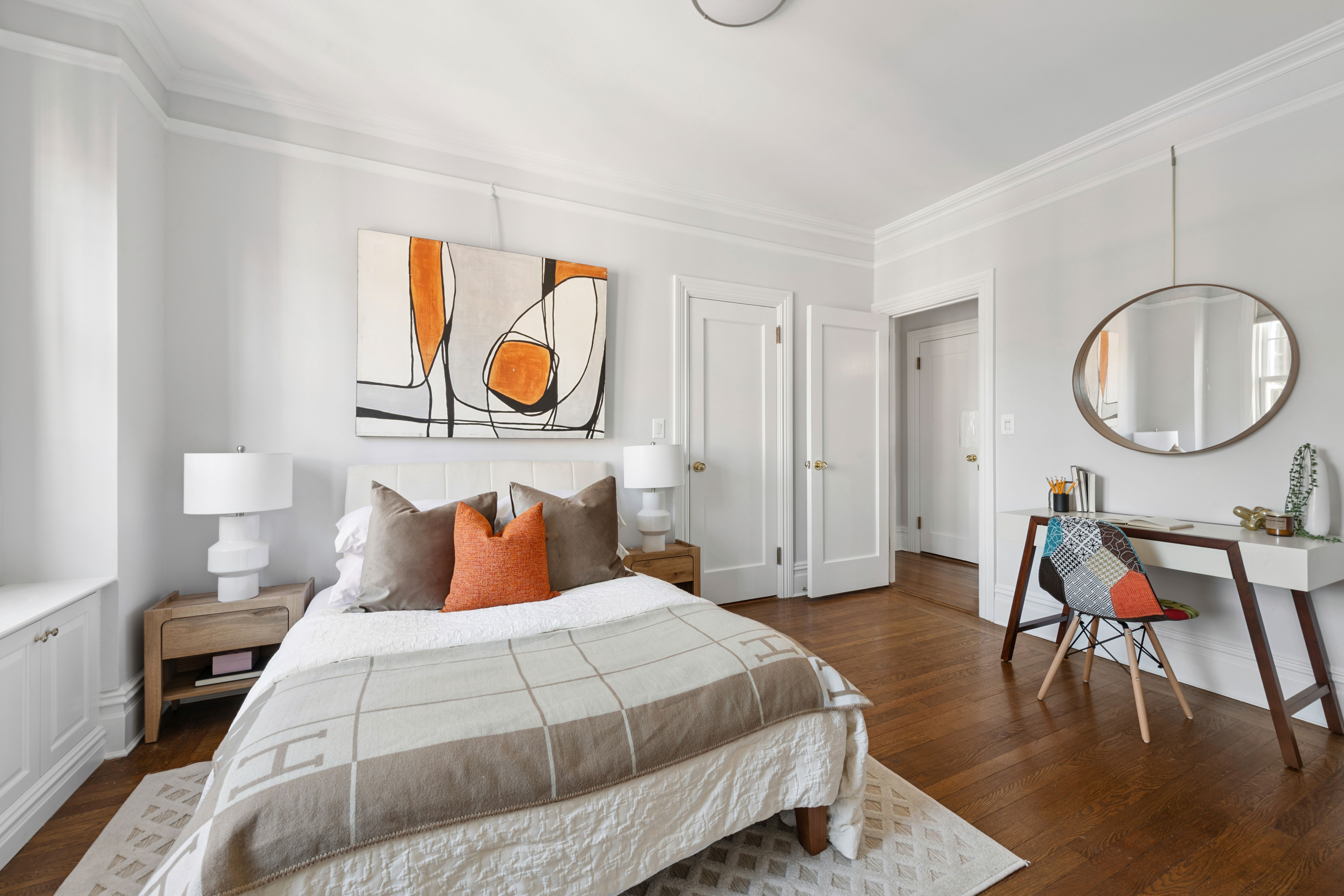 1140 5th Avenue, Unit 14B Manhattan, NY 10128 - Photo 8 of 18 a bedroom with a bed and a table in it