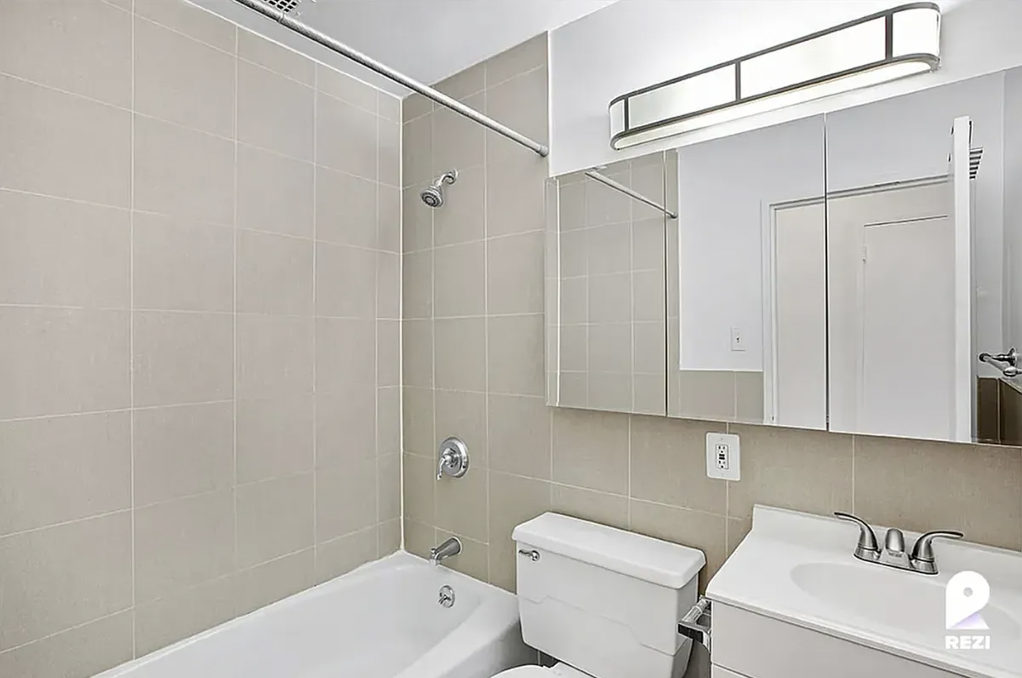 343 East 76th Street, Unit 2A Manhattan, NY 10021 - Photo 3 of 9 a bathroom with a sink a toilet and shower