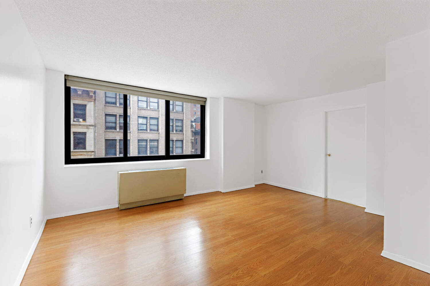 376 Broadway, Unit 6F Manhattan, NY 10013 - Photo 5 of 17 a view of an empty room with a window