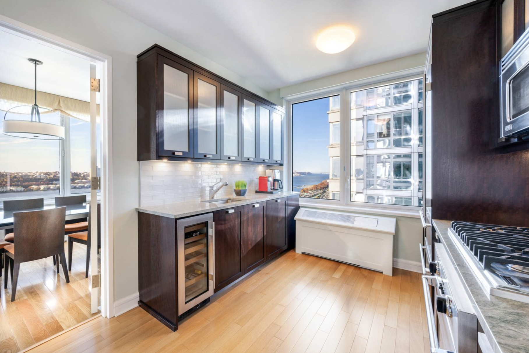 80 Riverside Boulevard, Unit 23C Manhattan, NY 10069 - Photo 5 of 19 a kitchen with stainless steel appliances granite countertop a stove and a refrigerator
