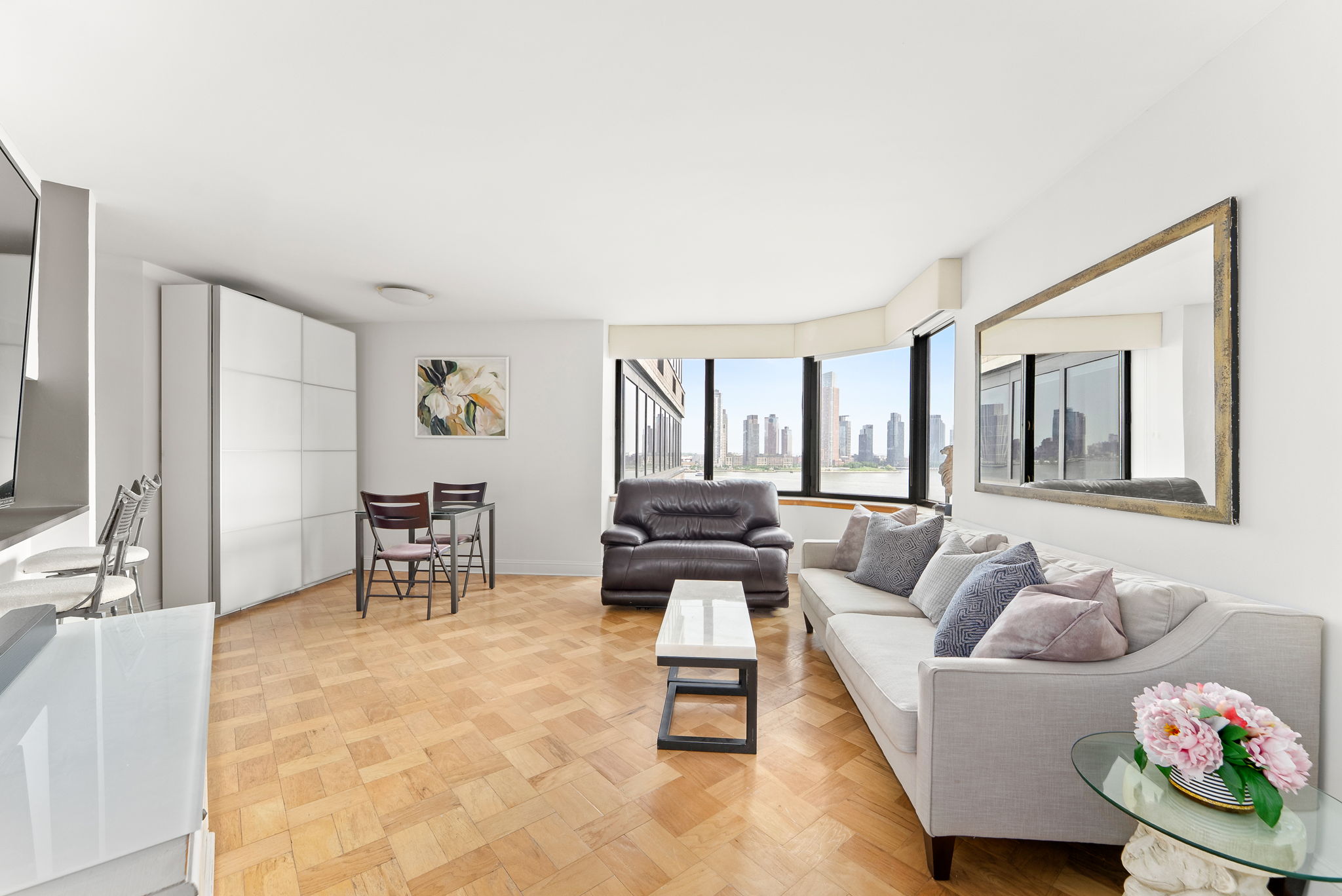 415 East 37th Street, Unit 9D Manhattan, NY 10016 - Photo 1 of 6 a living room with furniture and a table