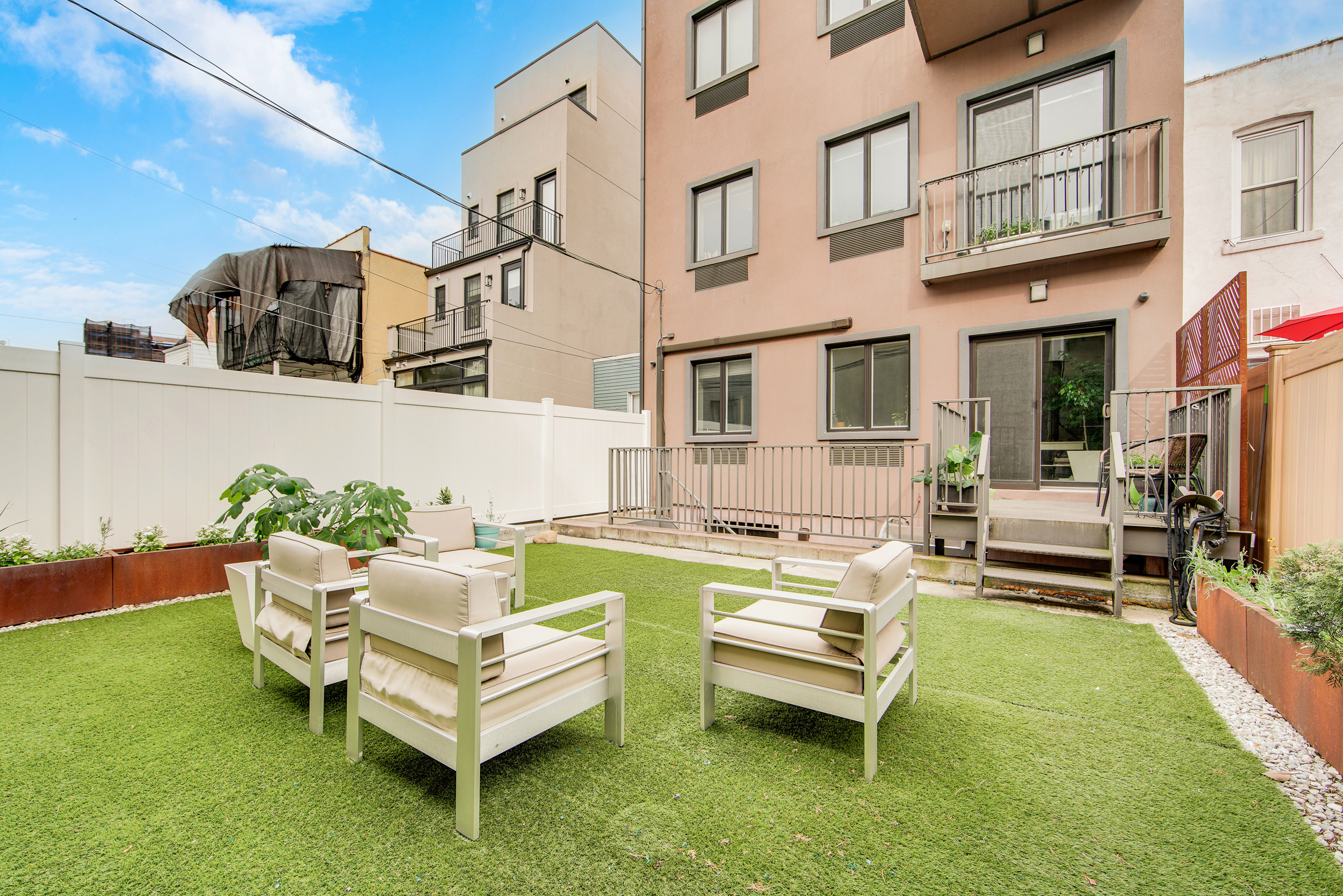 27-34 27th Street, Unit 1B Queens, NY 11102 - Photo 2 of 10 a swimming pool with outdoor seating and a garden