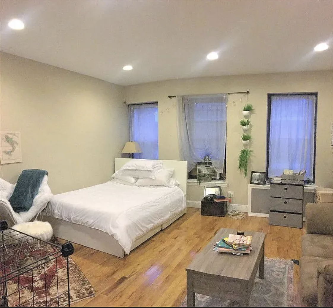 305 East 95th Street, Unit 4E Manhattan, NY 10128 - Photo 2 of 12 a bedroom with a bed and wooden floor