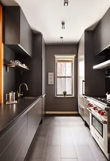 a kitchen with kitchen island granite countertop a sink and a stove
