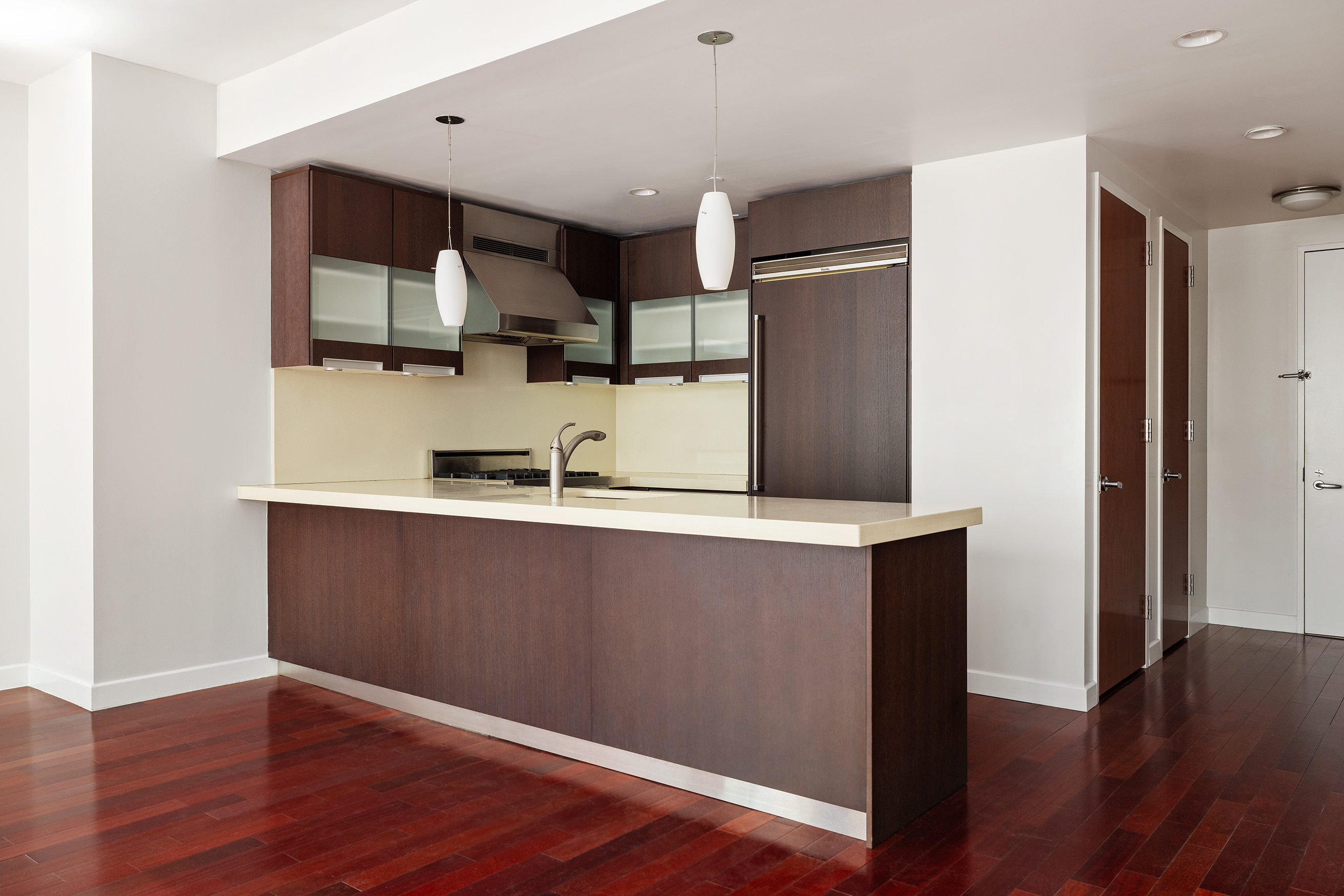 125 West 21st Street, Unit 5B Manhattan, NY 10011 - Photo 6 of 15 a kitchen with stainless steel appliances granite countertop a refrigerator and a sink