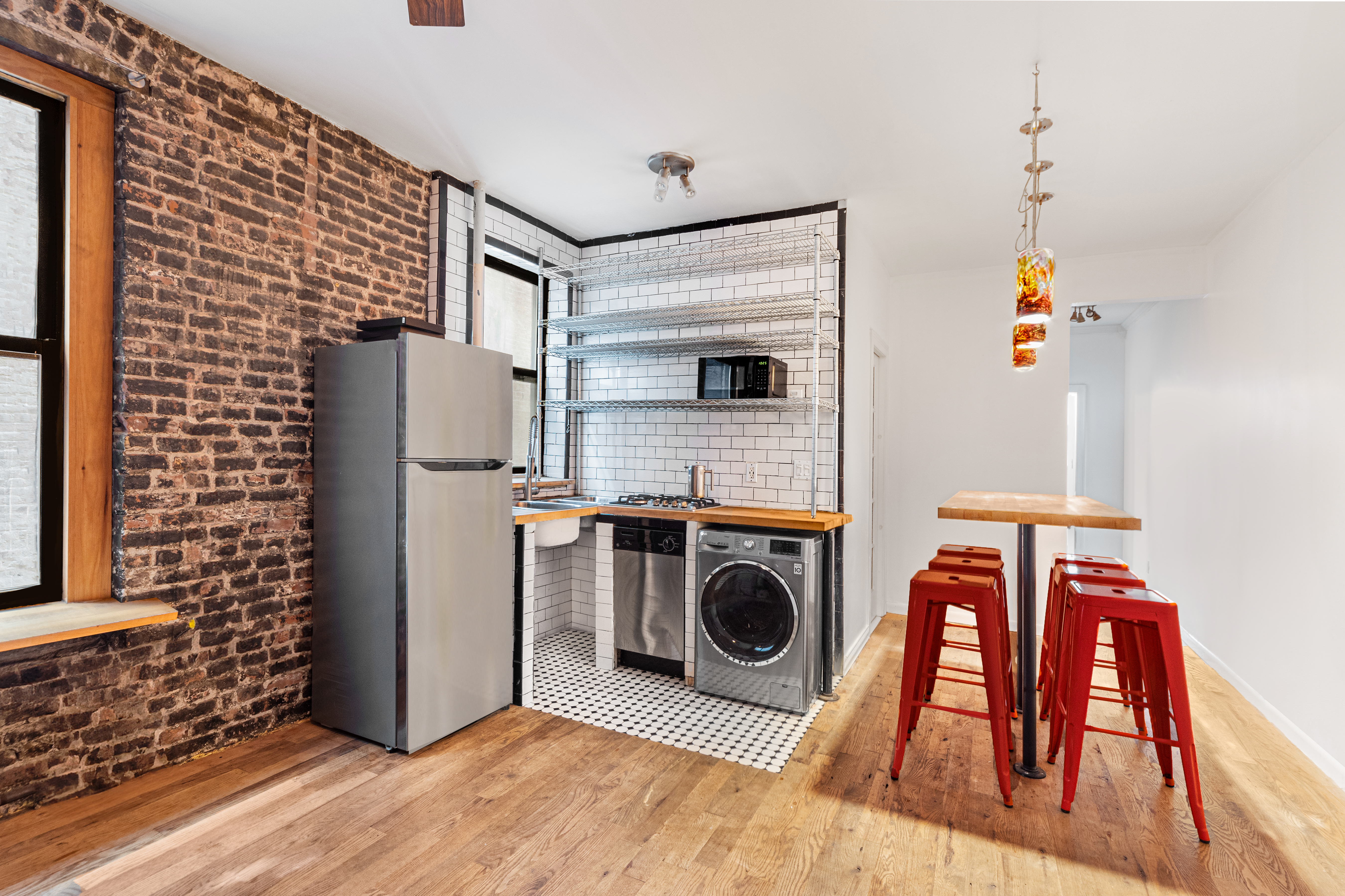 65 West 107th Street, Unit 2D Manhattan, NY 10025 - Photo 1 of 7 a view of kitchen with washer and dryer