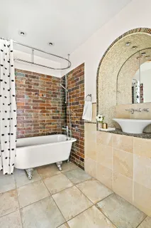 a bathroom with a bathtub and shower