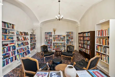 a living room with furniture a window and gym equipment