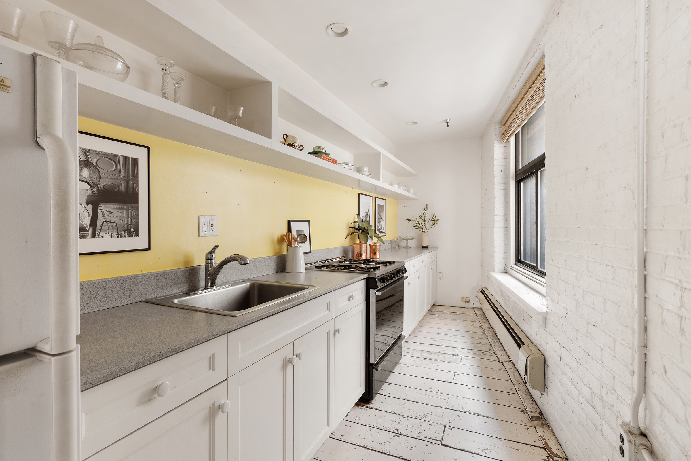 10 Leonard Street, Unit 6N Manhattan, NY 10013 - Photo 5 of 12 a kitchen with a sink and refrigerator