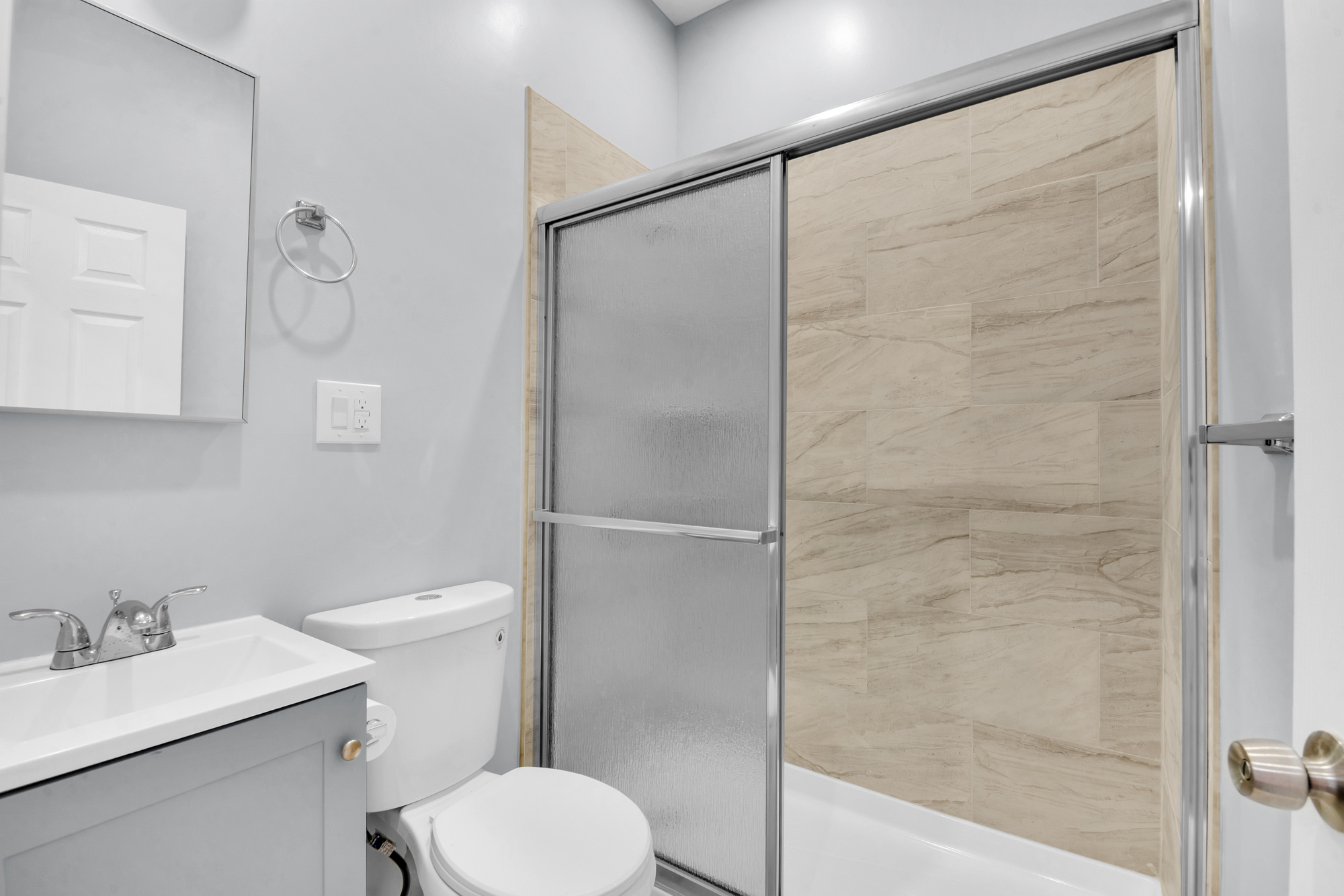 316 Lewis Avenue, Unit 2 Brooklyn, NY 11221 - Photo 3 of 8 a bathroom with a shower a toilet and sink