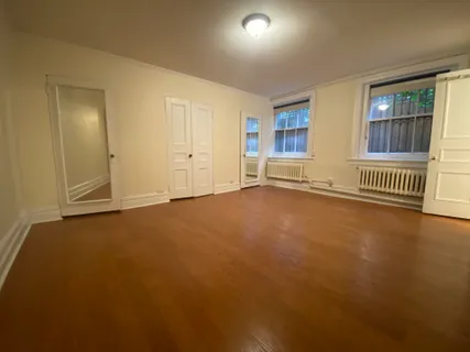 an empty room with a empty space and windows