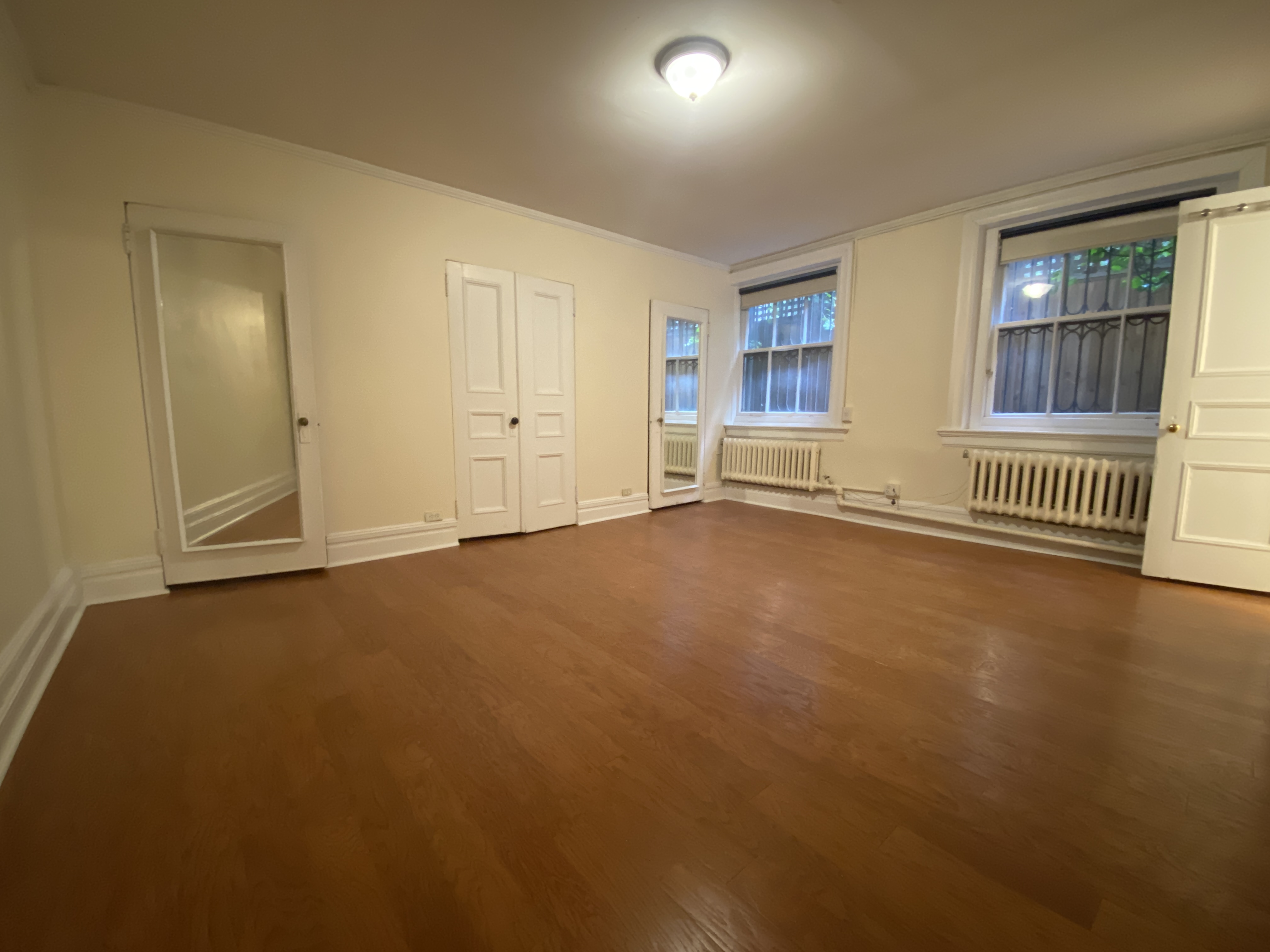 117 East 35th Street, Unit 1 Manhattan, NY 10016 - Photo 4 of 5 an empty room with a empty space and windows