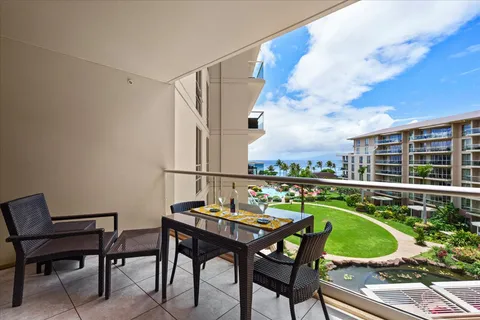 a view of a chairs and table in a balcony