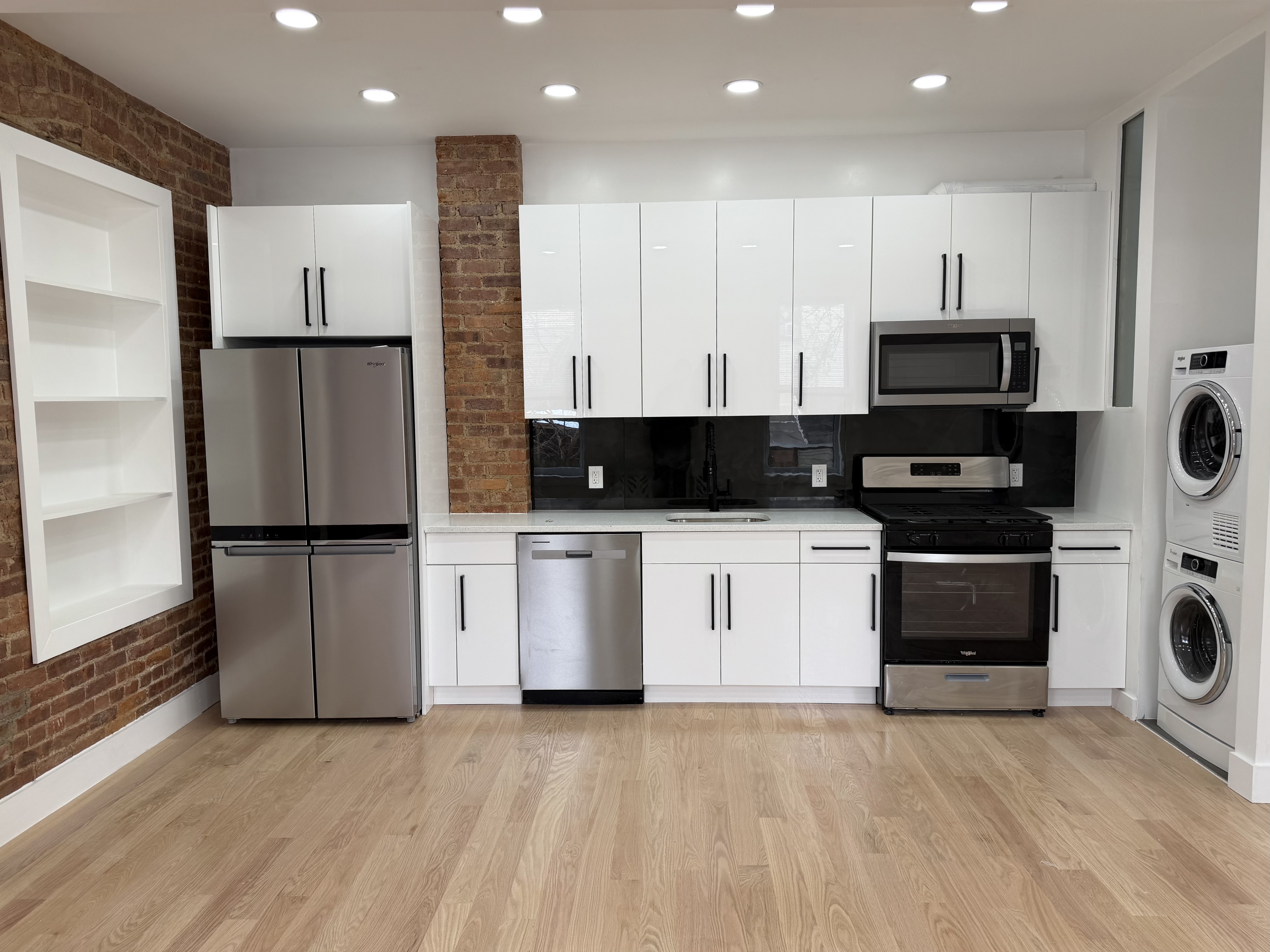 18-61 Dekalb Avenue, Unit 1 Queens, NY 11385 - Photo 2 of 12 a view of kitchen with refrigerator and microwave