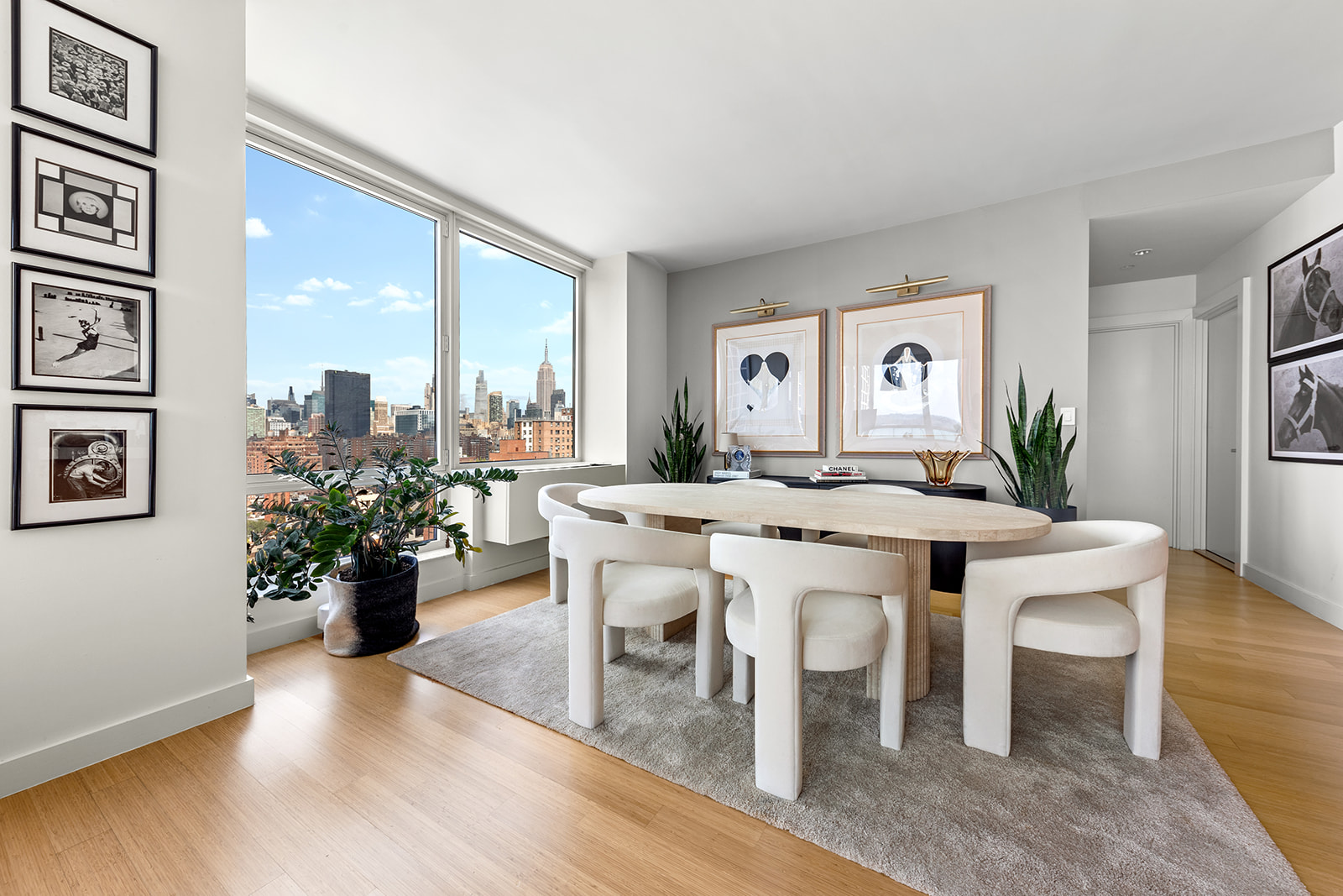 450 West 17th Street, Unit 2208 Manhattan, NY 10011 - Photo 2 of 8 a view of a dining room with furniture window and wooden floor