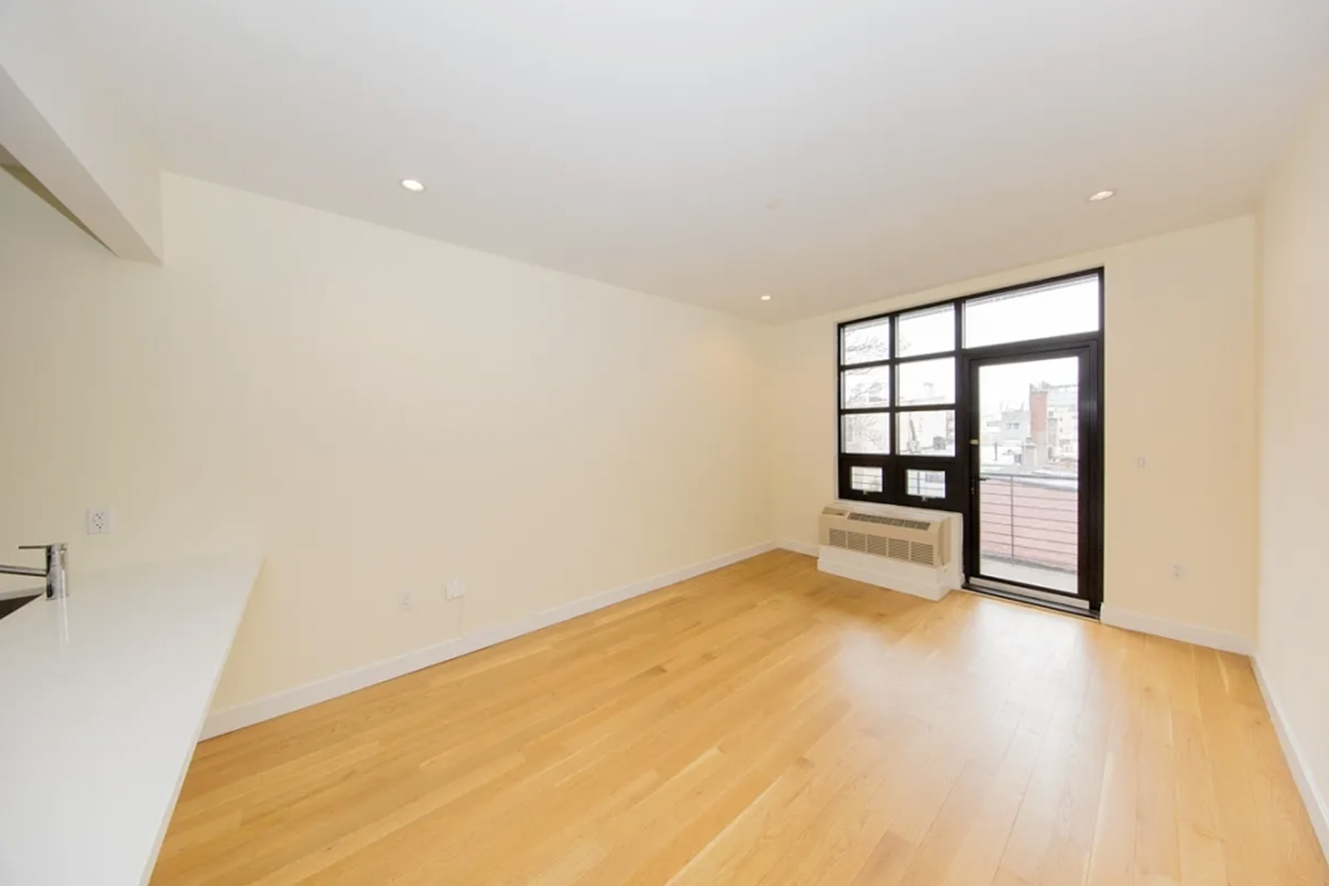 65 North 6th Street, Unit 5B Brooklyn, NY 11249 - Photo 3 of 5 wooden floor in an empty room with a window
