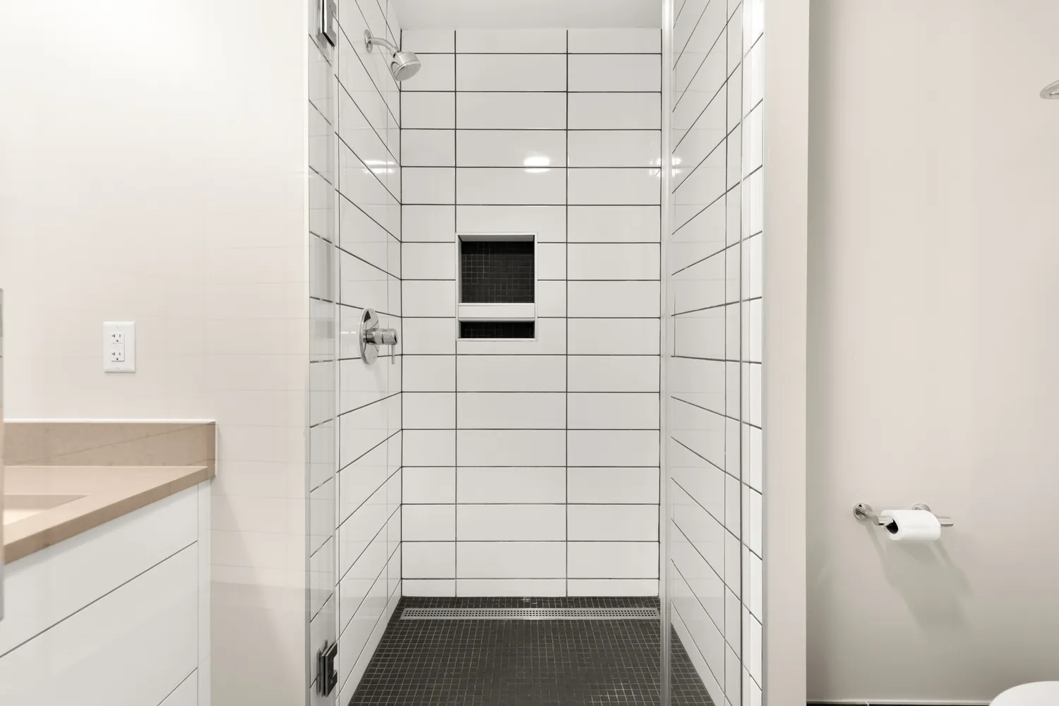 a bathroom with a shower and a sink