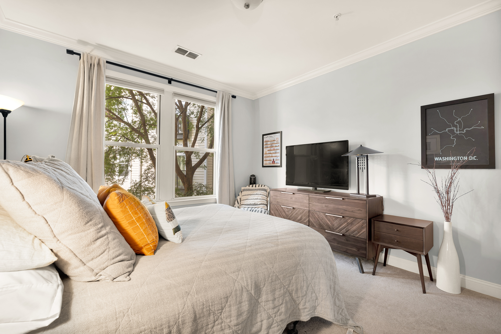 1391 Pennsylvania Ave. Southeast, Unit 324 Washington, DC 20003 - Photo 18 of 33 a bedroom with a bed and a flat tv screen next to a window