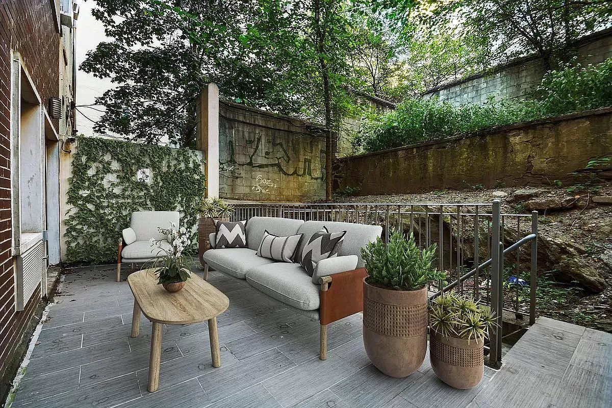 371 West 126th Street, Unit 1B Manhattan, NY 10027 - Photo 6 of 7 a roof deck with couches and a potted plant on a wooden floor
