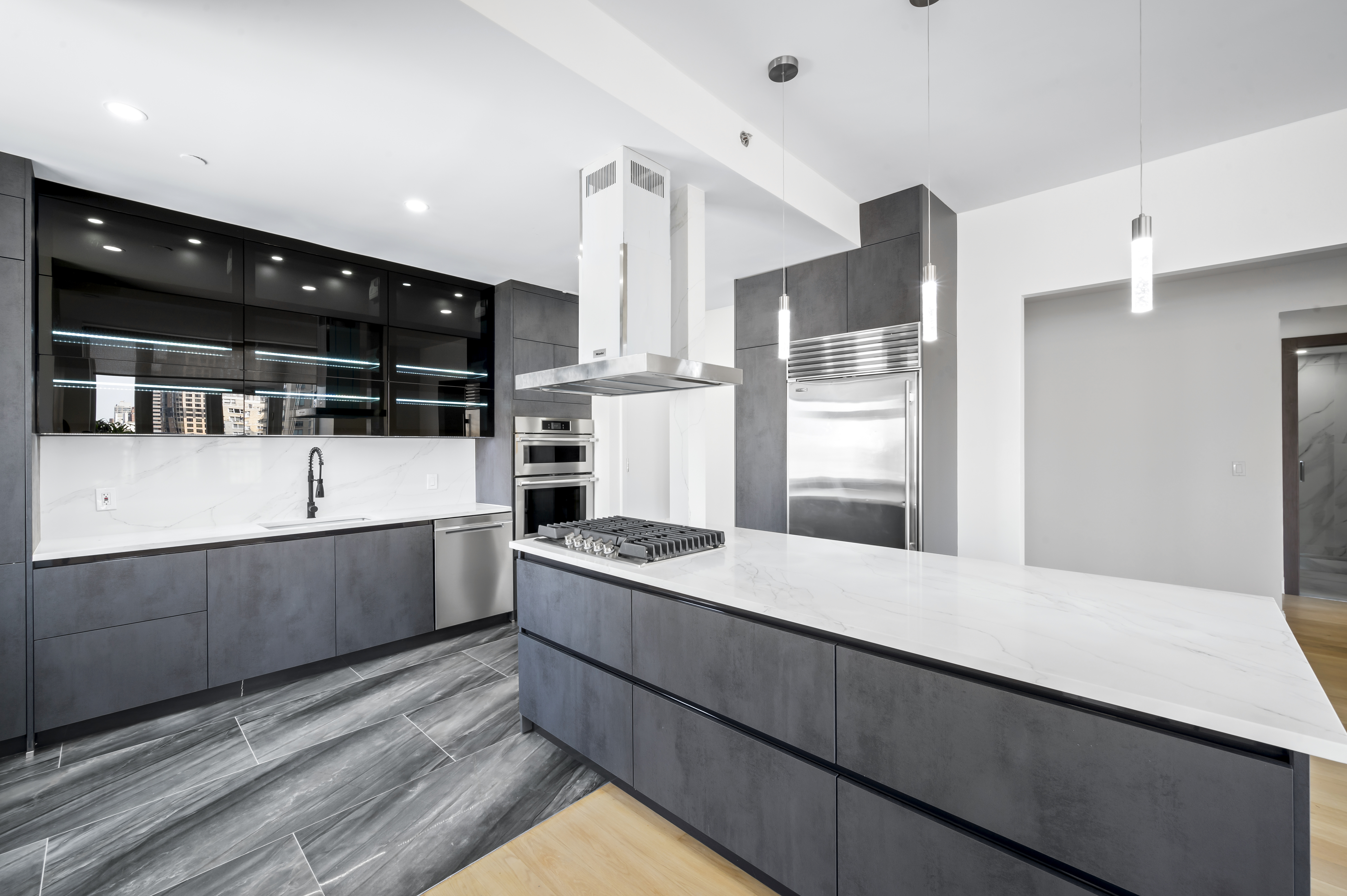408 East 79th Street, Unit 16B Manhattan, NY 10075 - Photo 4 of 16 a kitchen with stainless steel appliances kitchen island granite countertop a refrigerator and a stove