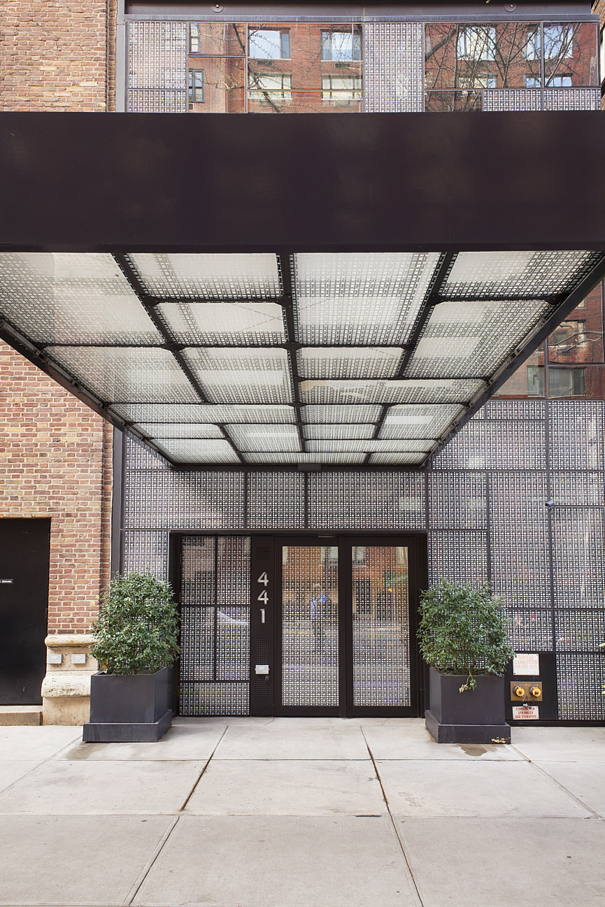 441 East 57th Street, Unit 5 Manhattan, NY 10022 - Photo 6 of 7 a front view of a building with potted plants