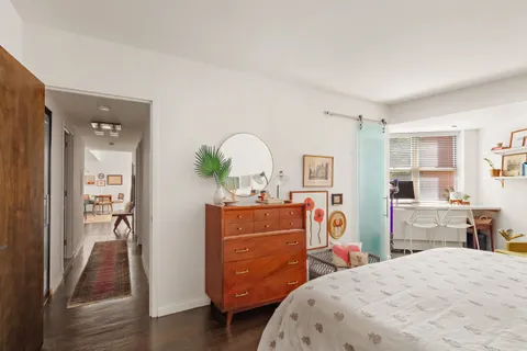 a bed room with a bed and a dresser