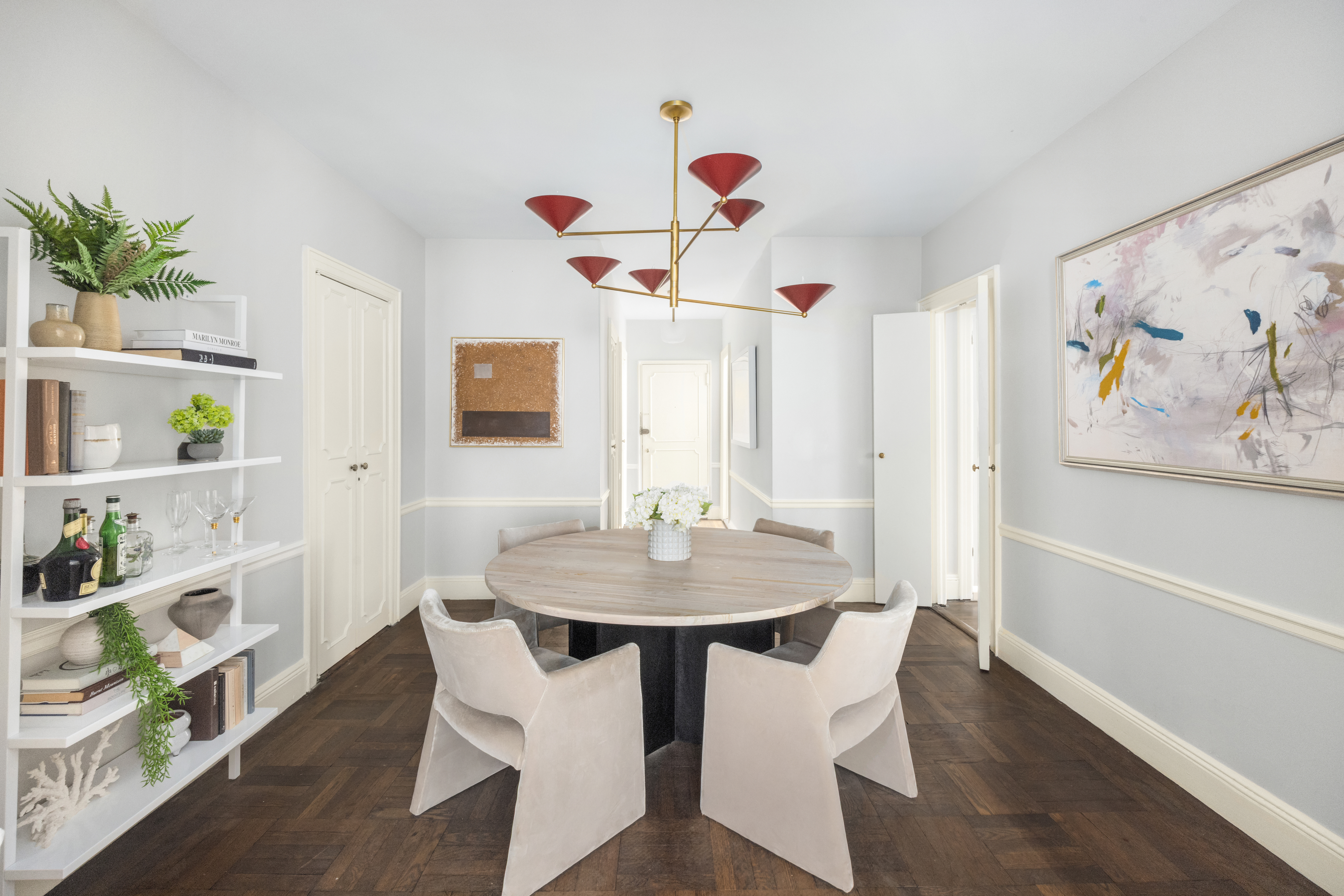 993 Park Avenue, Unit 4C Manhattan, NY 10028 - Photo 3 of 15 a view of a dining room with furniture and wooden floor