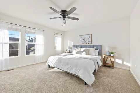 a spacious bedroom with a large bed and a window