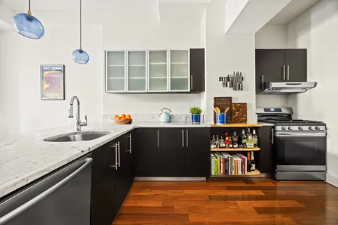 a kitchen with stainless steel appliances granite countertop a sink and a stove