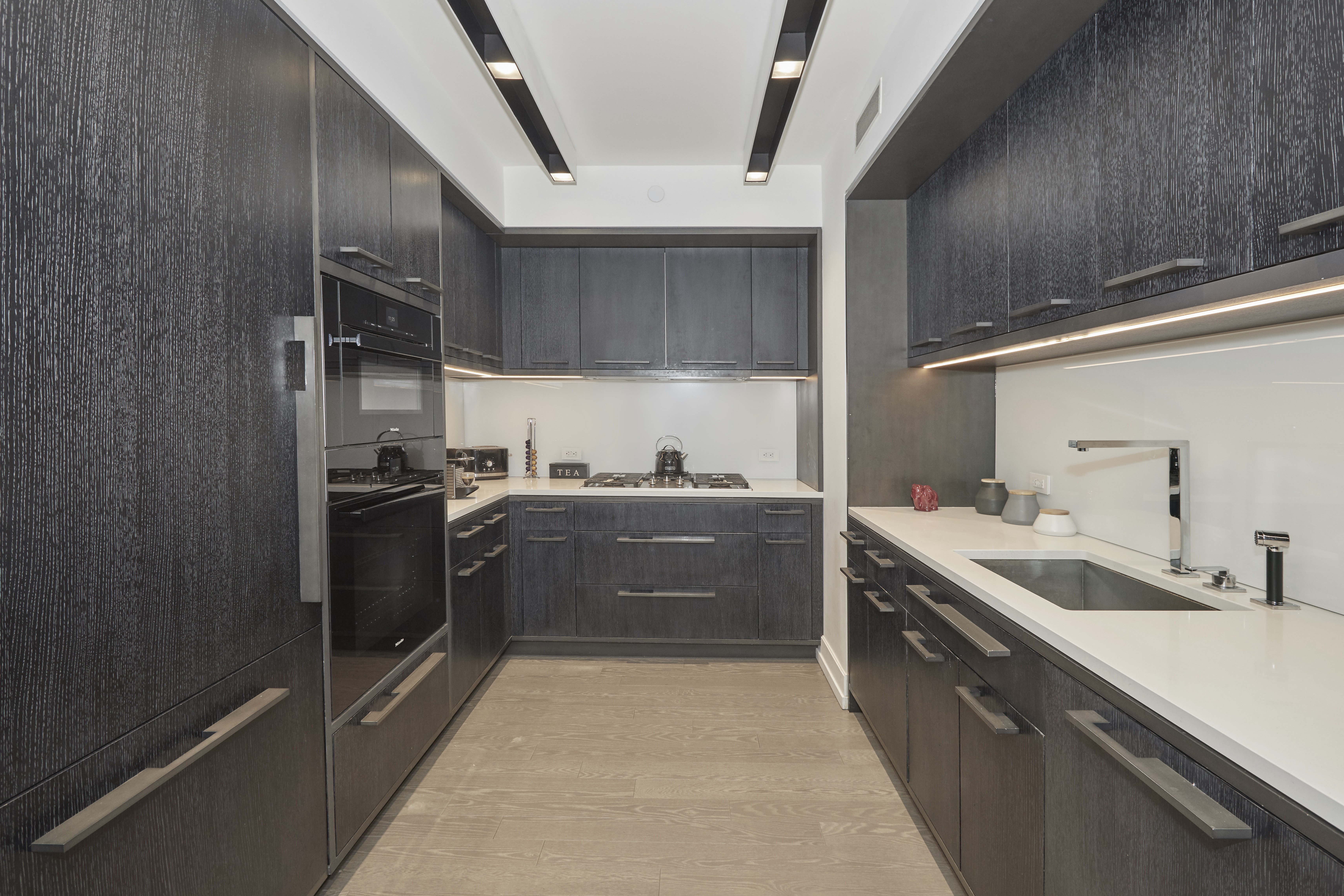 70 Charlton Street, Unit 7E Manhattan, NY 10014 - Photo 6 of 17 a kitchen with a sink a stove and refrigerator