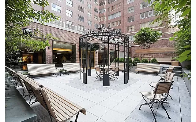 a view of a patio with a table and chairs and potted plants