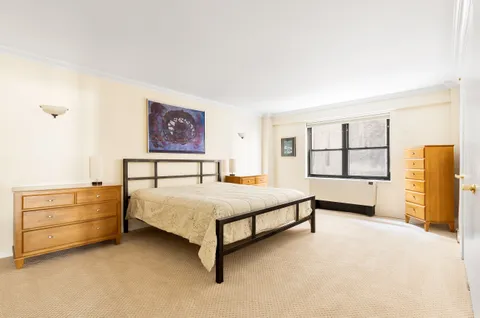 a spacious bedroom with a bed and a window