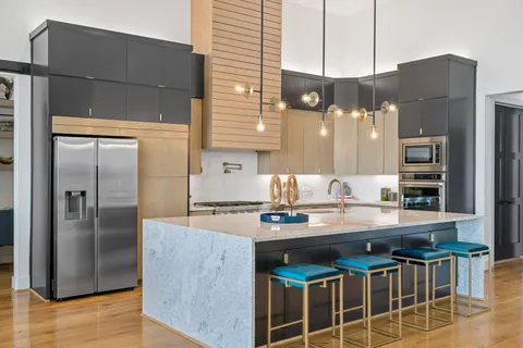 a kitchen with a sink a refrigerator and cabinets