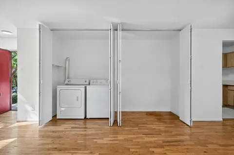 a view of a room with wooden floor