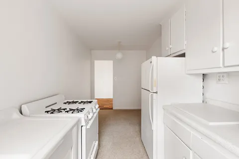 a kitchen with a refrigerator and a sink