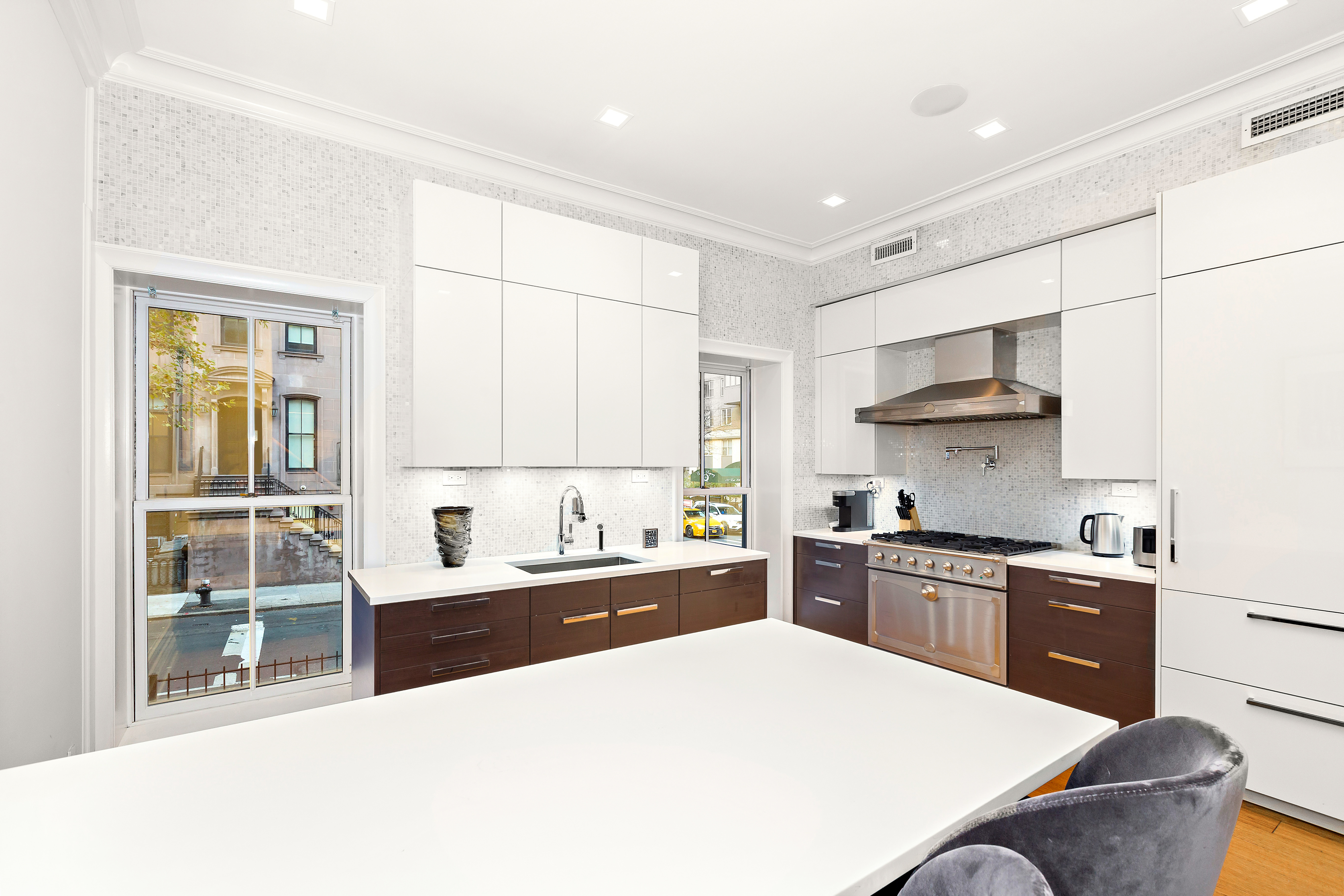 134 East 36th Street Manhattan, NY 10016 - Photo 4 of 28 a kitchen with a stove a sink and a refrigerator