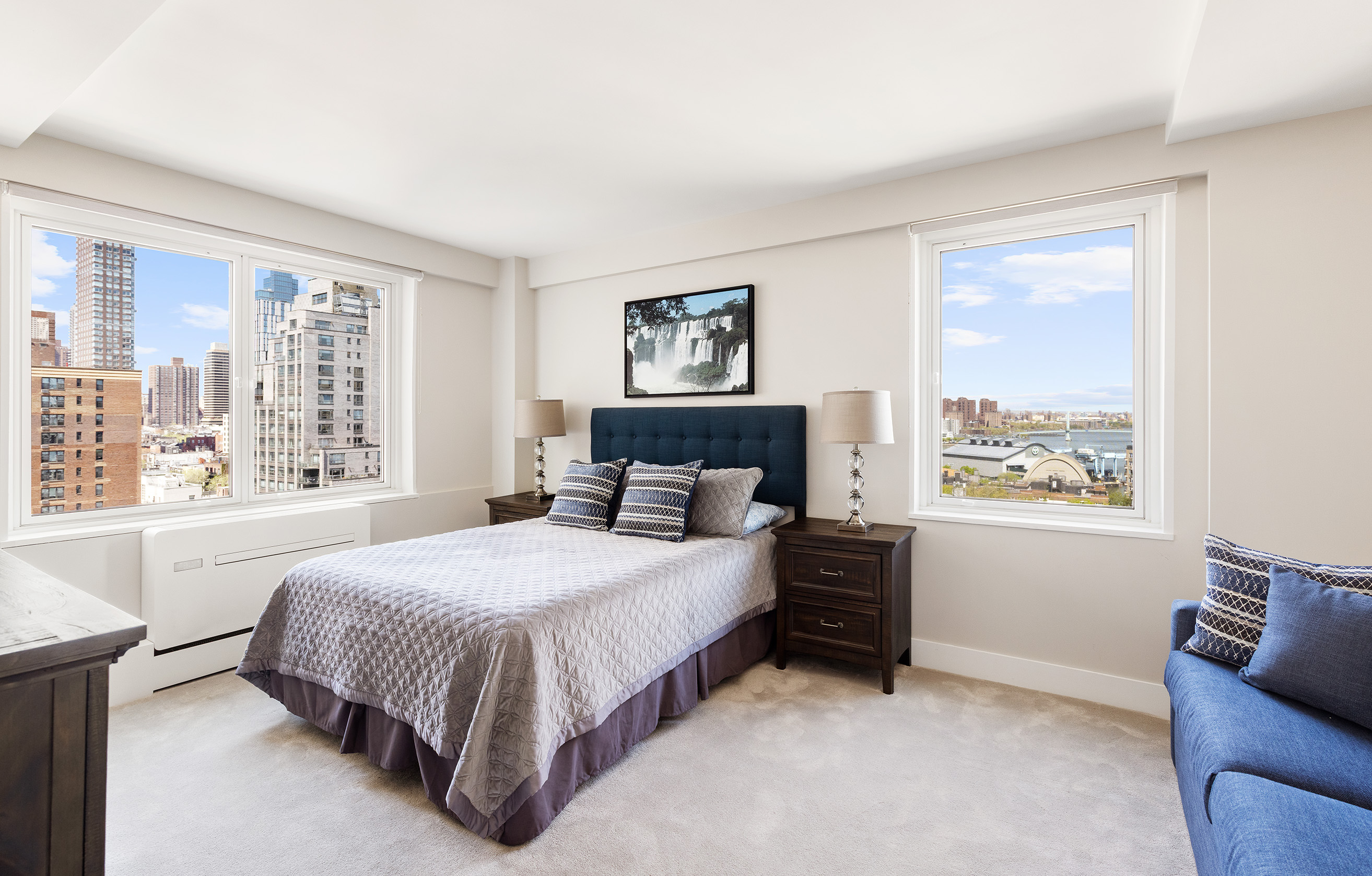 535 East 86th Street, Unit 16F Manhattan, NY 10028 - Photo 11 of 19 a bedroom with a bed lamp and a large window
