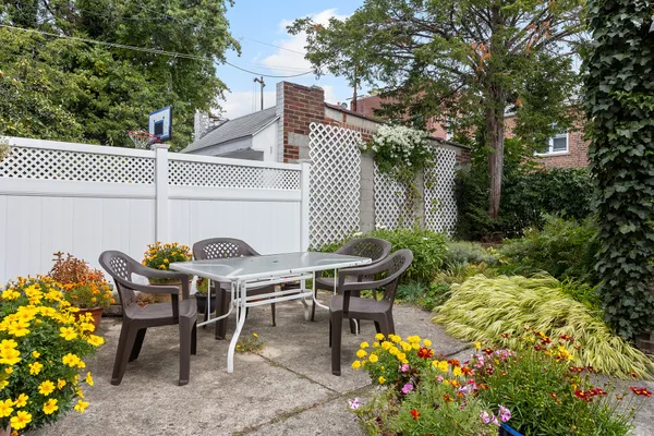 a backyard of a house with table and chairs