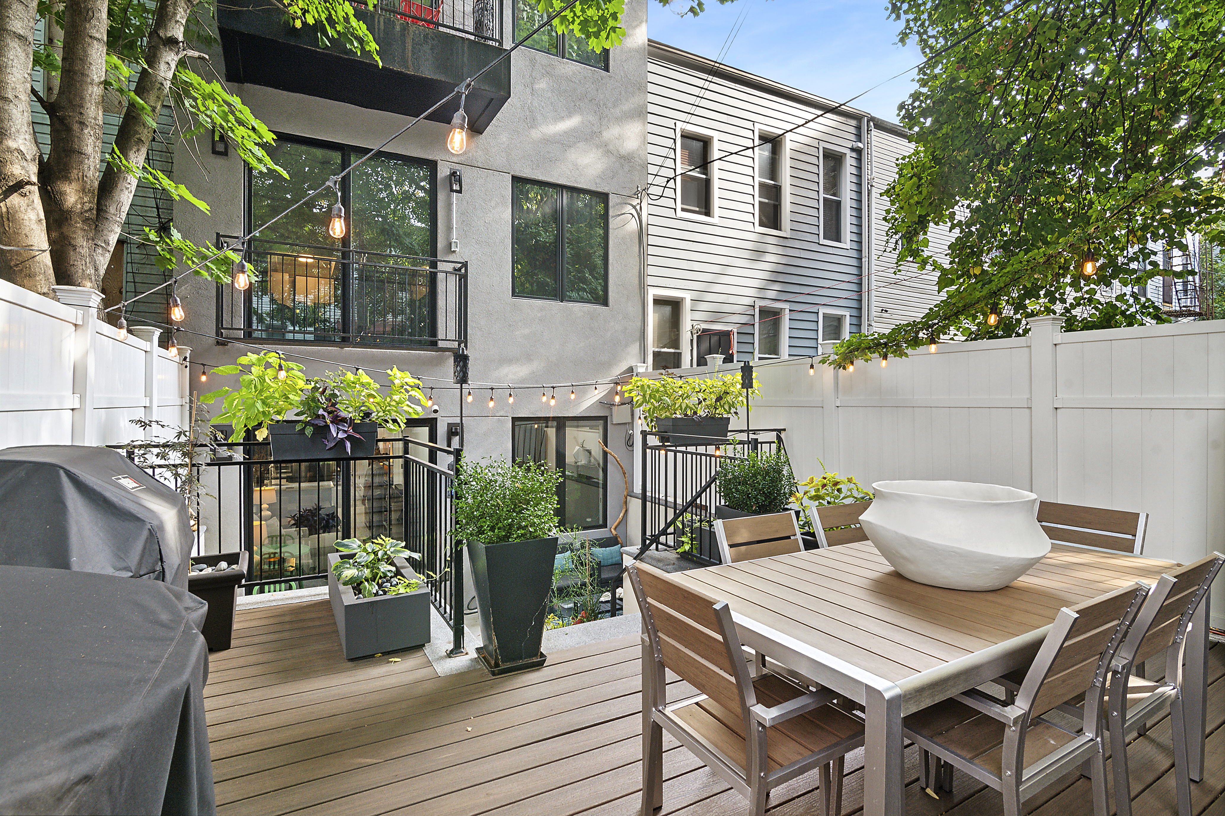 1043 Halsey Street, Unit 1 Brooklyn, NY 11207 - Photo 3 of 14 a view of a patio with table and chairs and potted plants