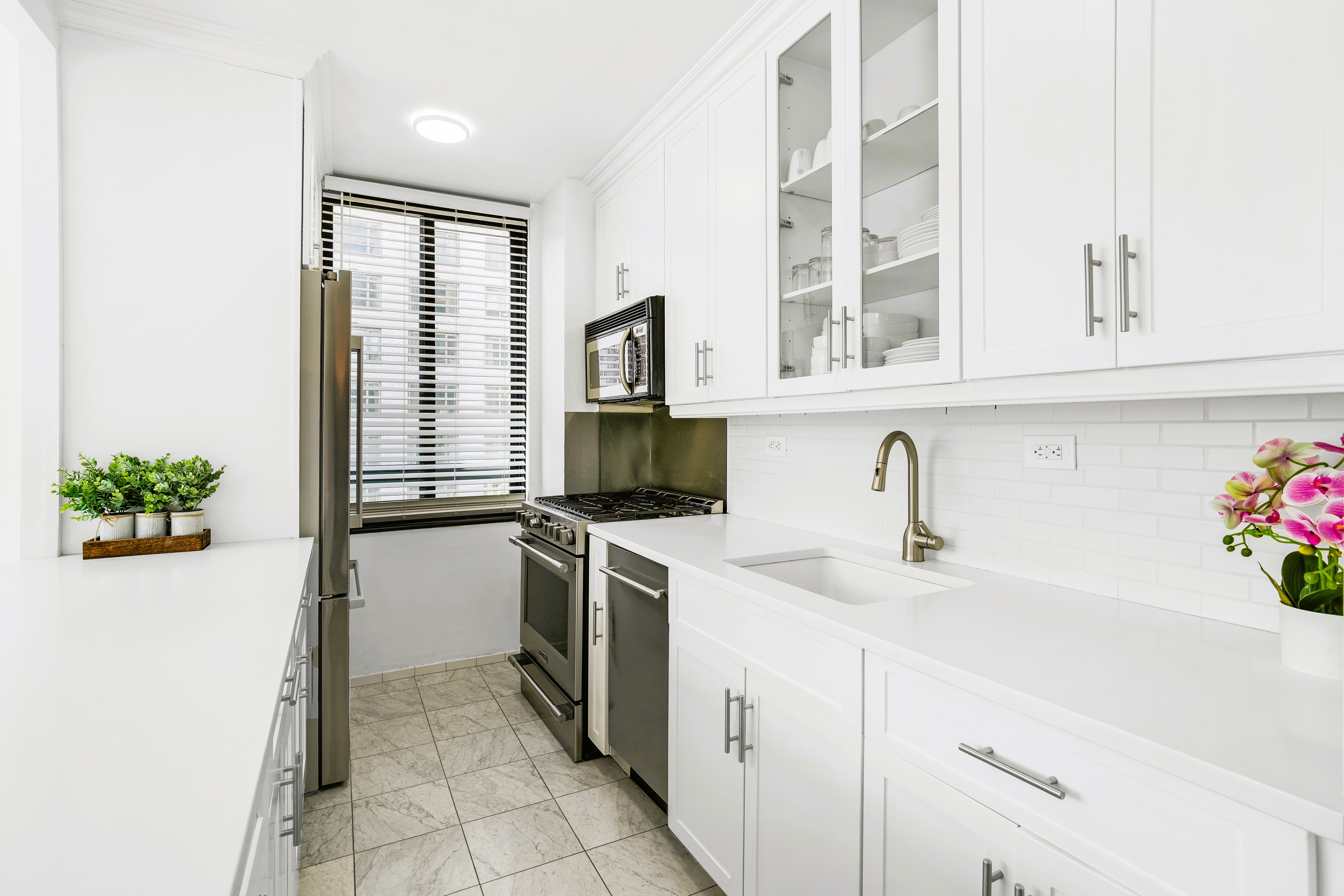 171 East 84th Street, Unit 4B Manhattan, NY 10028 - Photo 9 of 20 a kitchen with stainless steel appliances granite countertop a sink and a granite counter tops