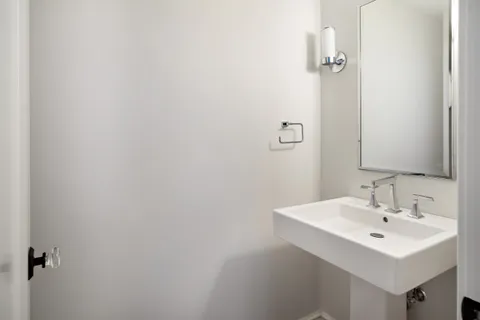 a bathroom with a sink a mirror and vanity