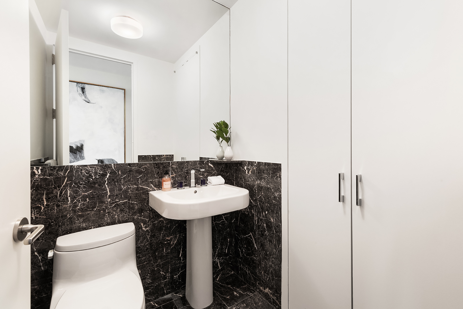 1 Central Park West, Unit 30E Manhattan, NY 10023 - Photo 11 of 12 a bathroom with a sink toilet and mirror