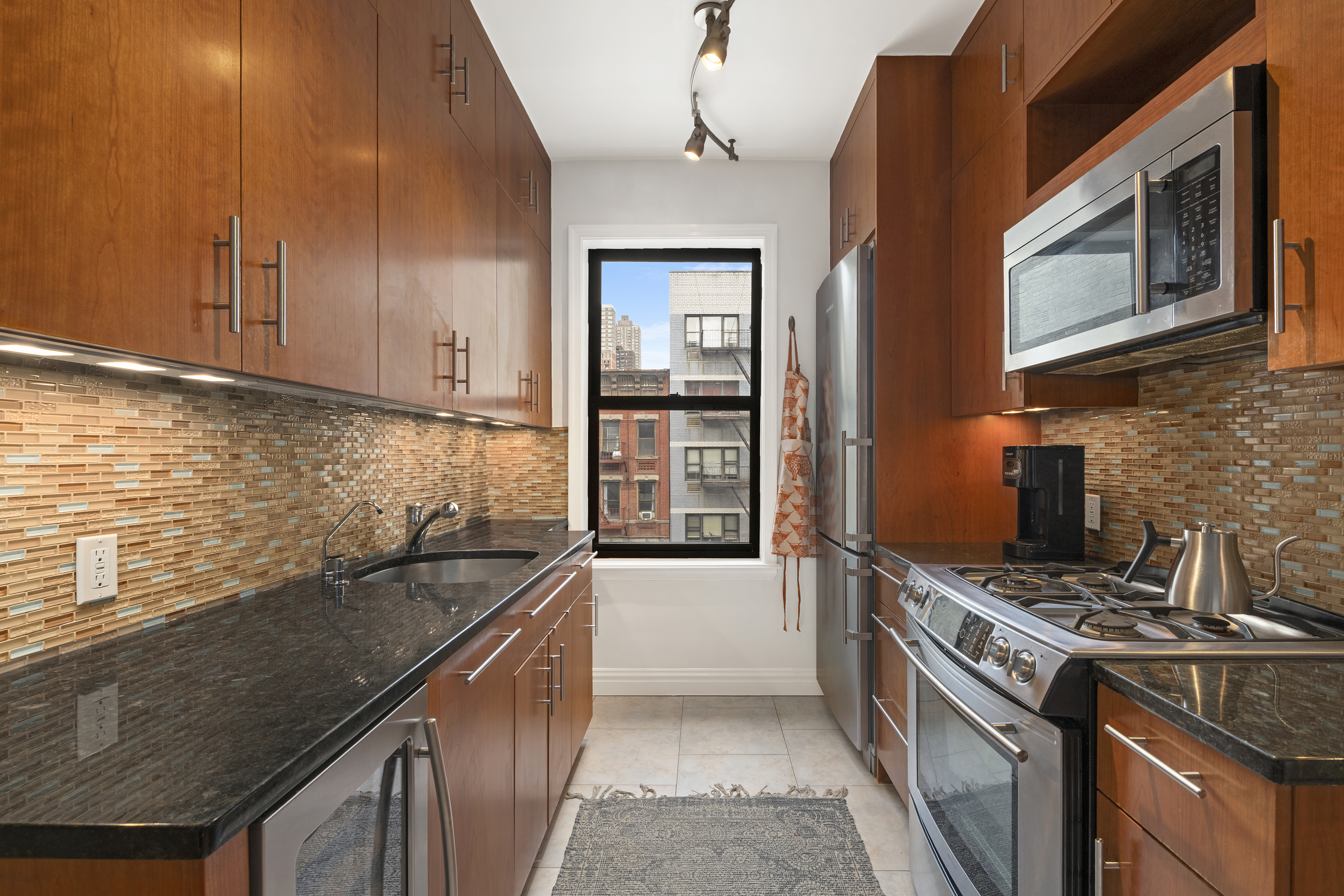 222 East 82nd Street, Unit 5E Manhattan, NY 10028 - Photo 3 of 10 a kitchen that has a sink and a stove