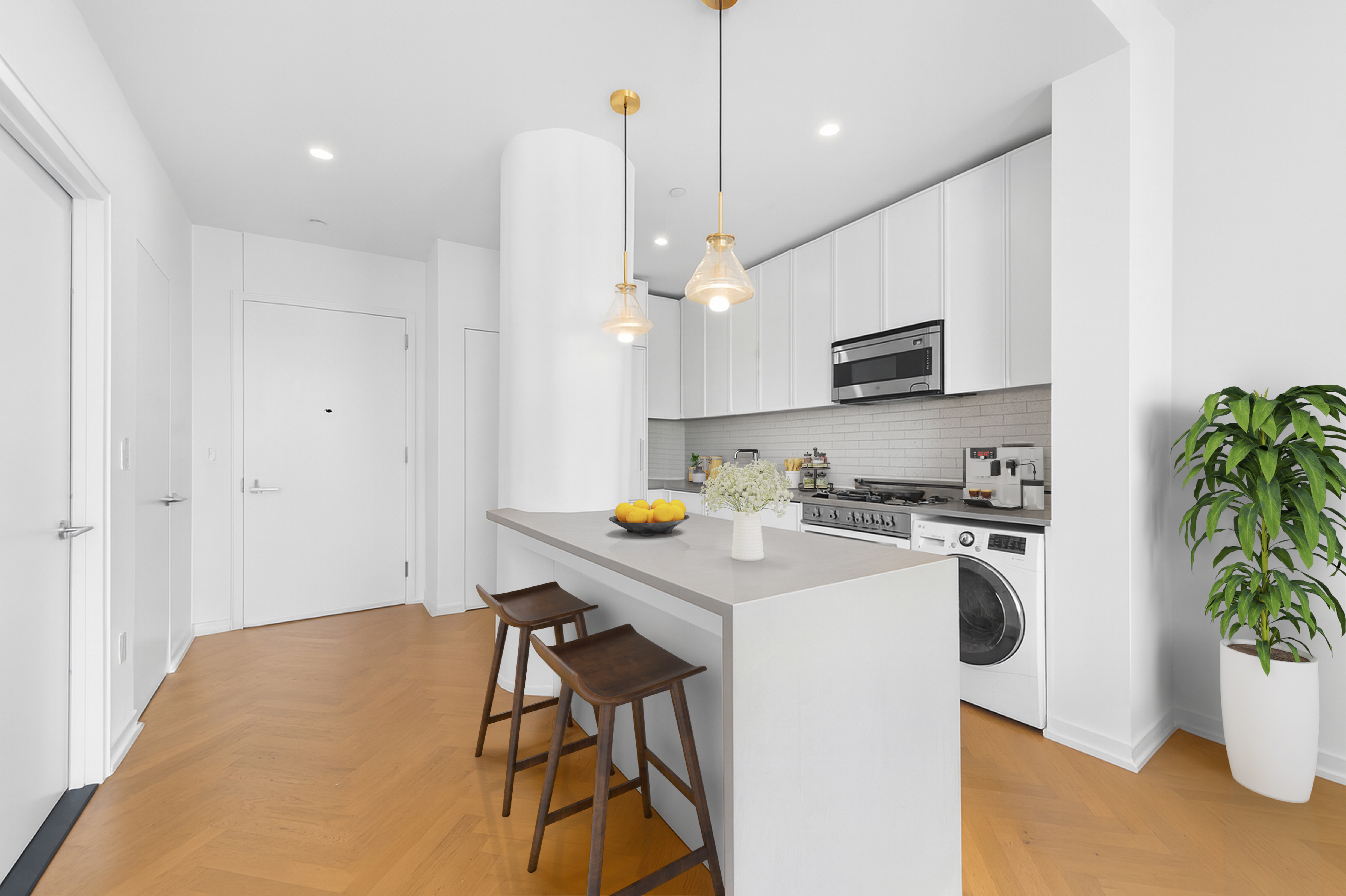 184 Kent Avenue, Unit B407 Brooklyn, NY 11249 - Photo 3 of 14 a kitchen with stainless steel appliances a stove a sink a microwave a refrigerator and cabinets
