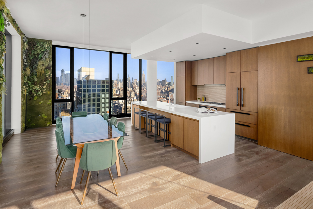 570 Broome Street, Unit PHB Manhattan, NY 10013 - Photo 5 of 23 a kitchen with a table chairs refrigerator and wooden floor