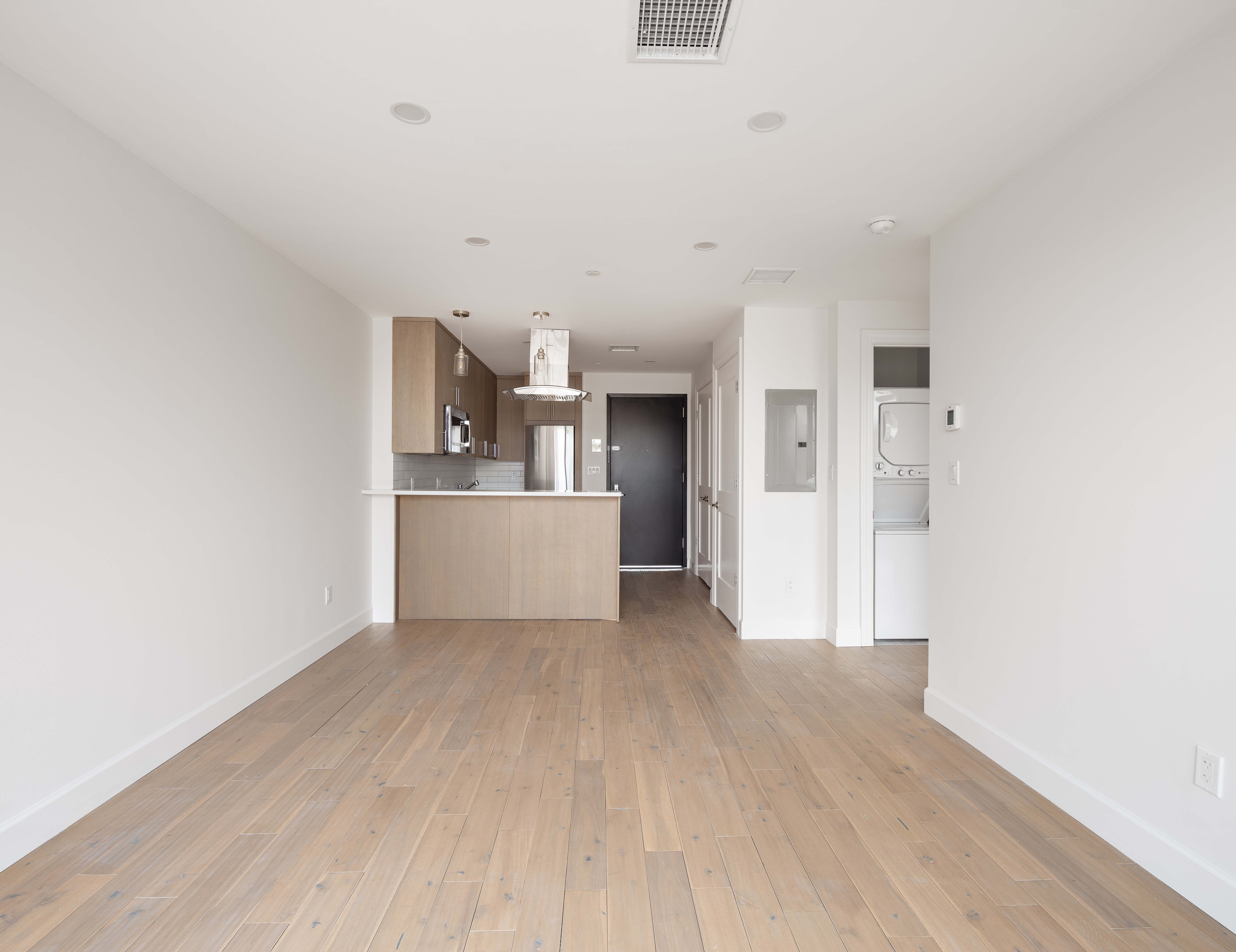 a view of a kitchen with wooden floor