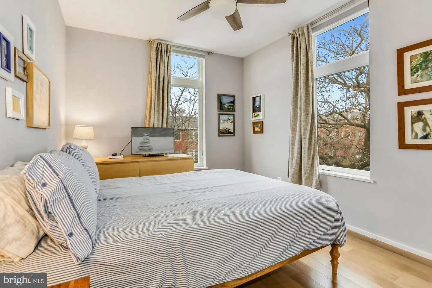 a bedroom with a bed and a painting on the wall