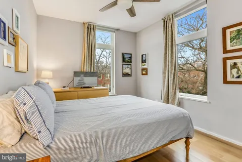 a bedroom with a bed and a painting on the wall