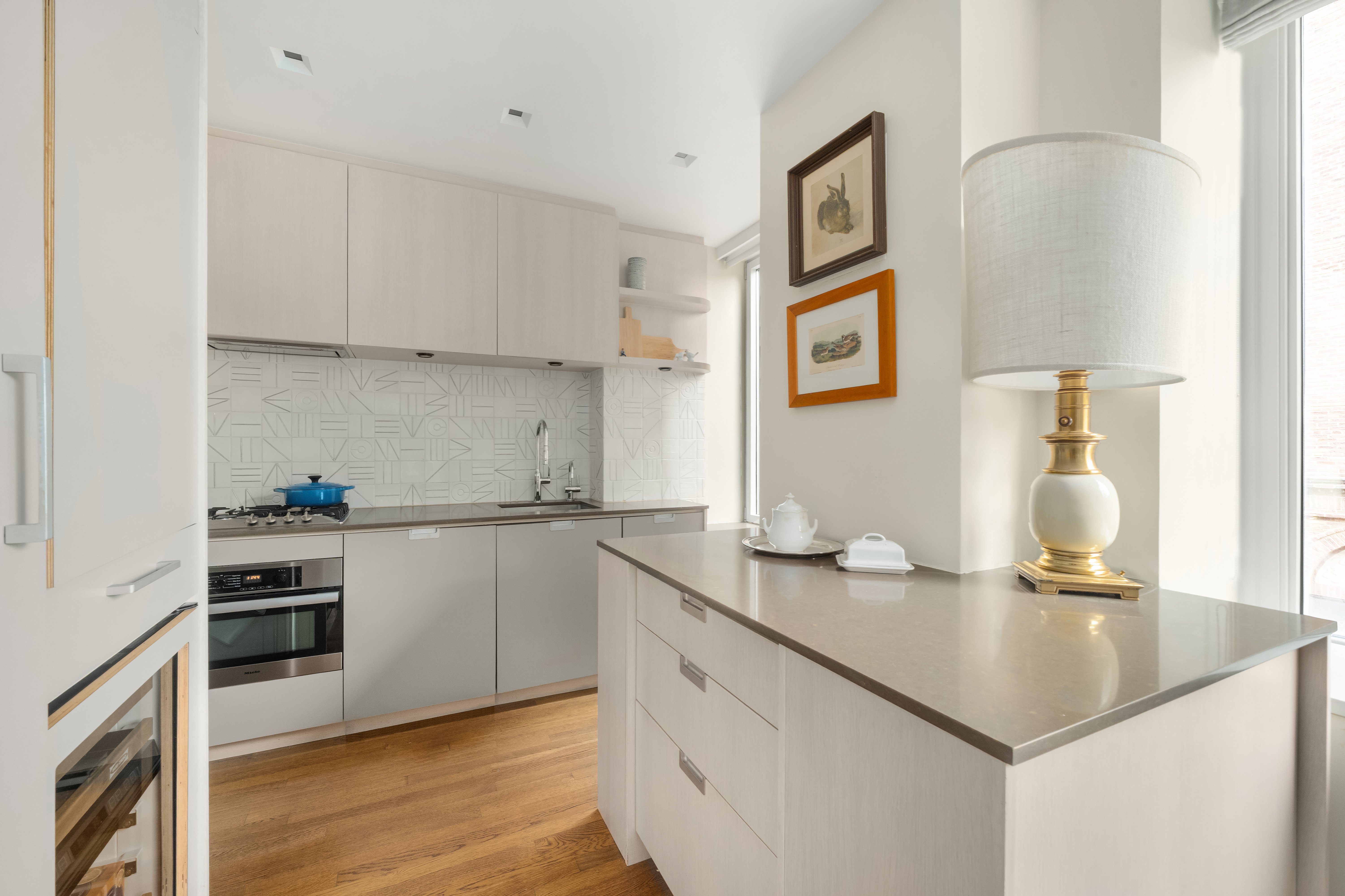 455 East 51st Street, Unit 2F Manhattan, NY 10022 - Photo 6 of 17 a kitchen with a sink cabinets and wooden floor